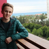 Alper, with blonde hair and a smiling face.